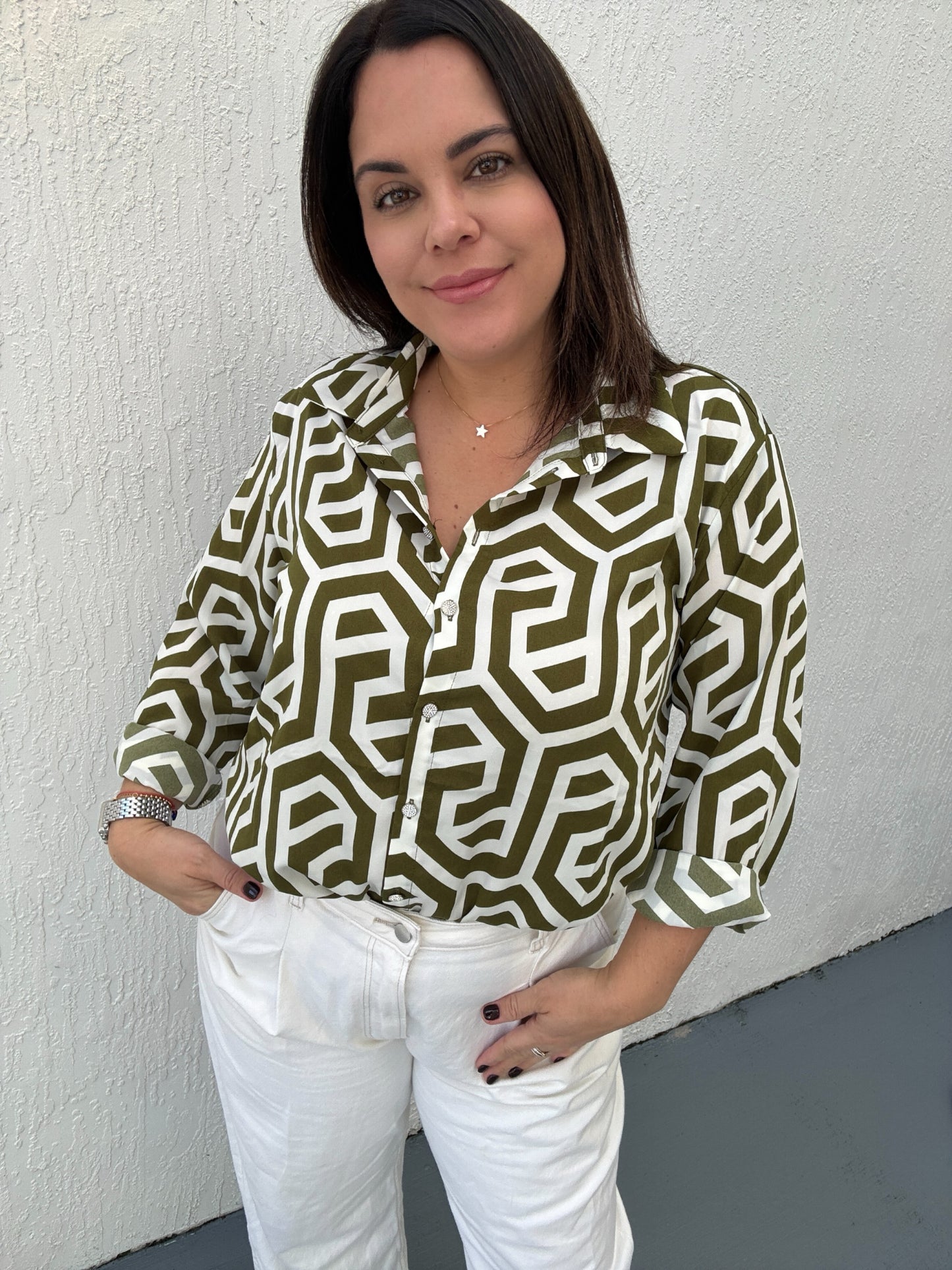 A women with a white and olive  Geometric printed long sleeve top