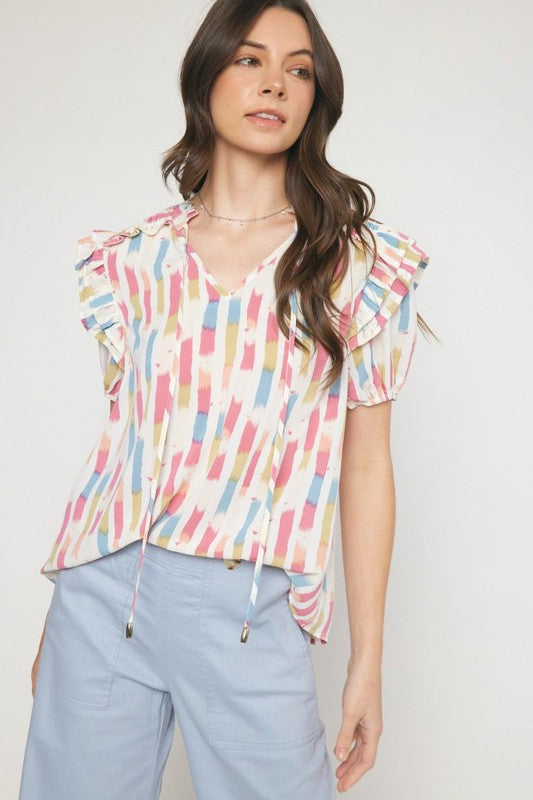 A Women with a pastel colors vtop with blue, red and yellow colors