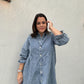 A woman with a Washed Denim Puff Sleeve dress