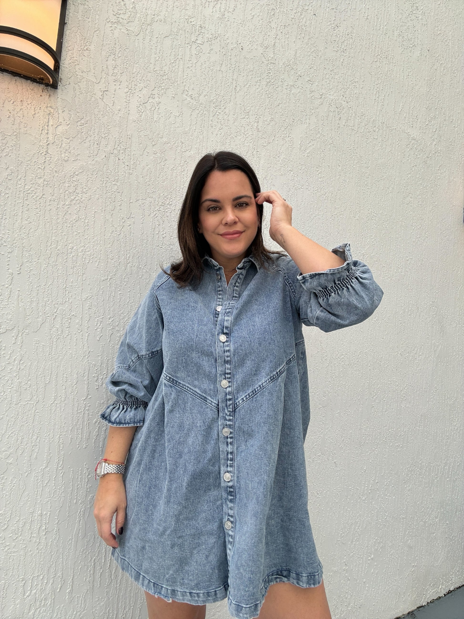 A woman with a Washed Denim Puff Sleeve dress