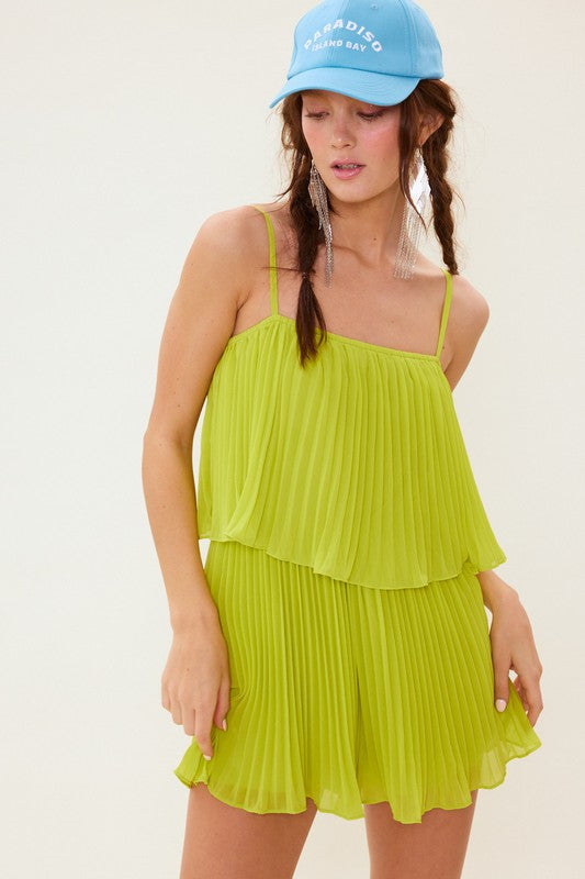 This photo shows a lime green romper with pleated detailing. The romper is made from 100% polyester and is perfect for a summer day or a night out.